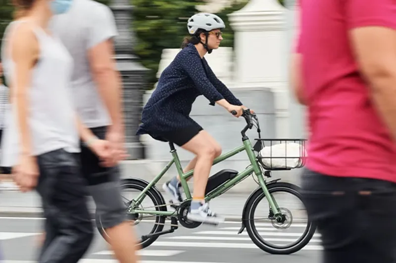Womean riding an Electric urban bike through the city