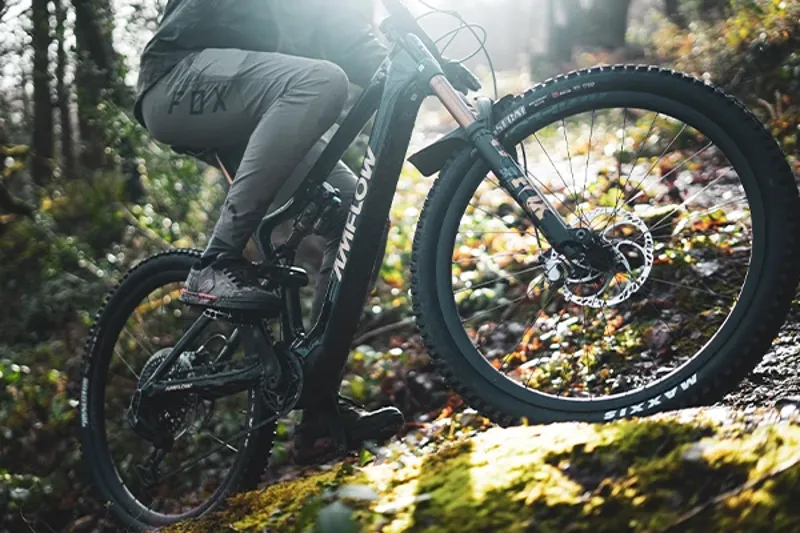 Riding a tech climb on an Amflow eMTB