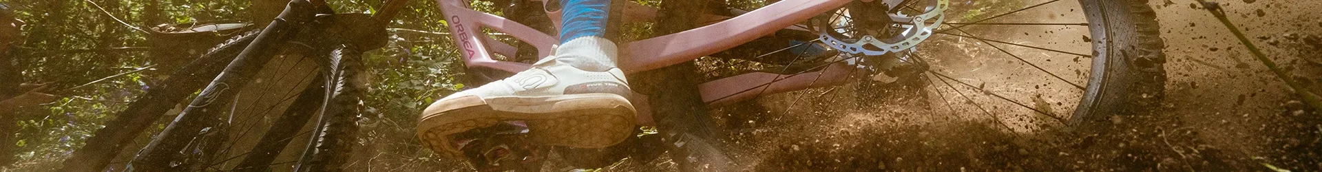 DH Mountain biking closeup with roost & dust