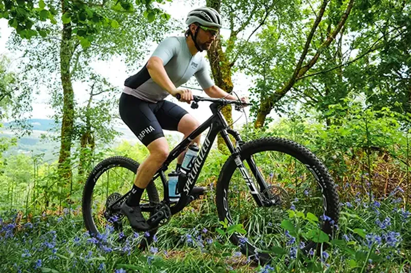 Riding a Merida cross-country mountain bike on wide open track in the hills