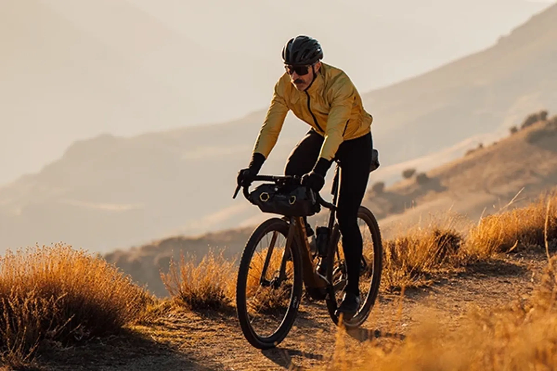 Electric gravel bike riding on mixed terrain