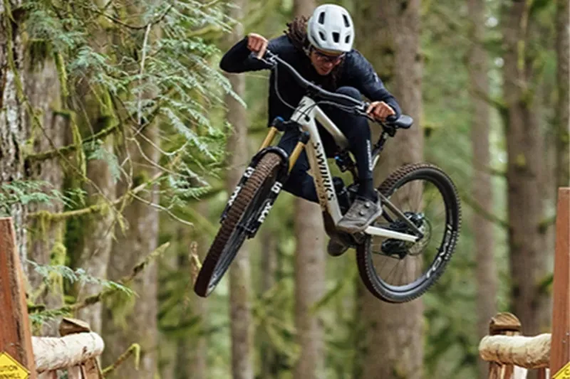 Specialized Turbo Levo SL lightweight e-MTB jumping on a trail