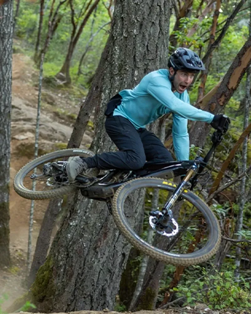 Rder getting steezy jumping in the woods on a Trek Fuel+ MX