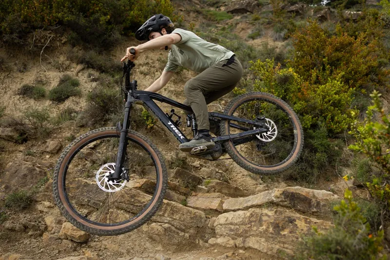 Trek Fuel+ e-MTB riding on technical trail terrain